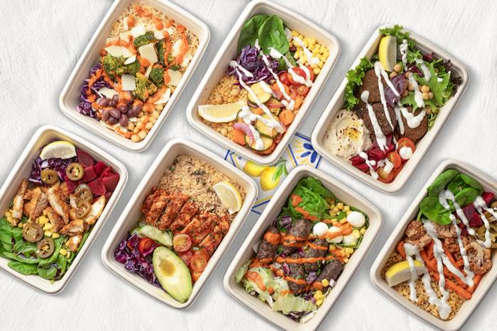 Bonata's lunch trays from above: falafel, harissa chicken, salmon and salads